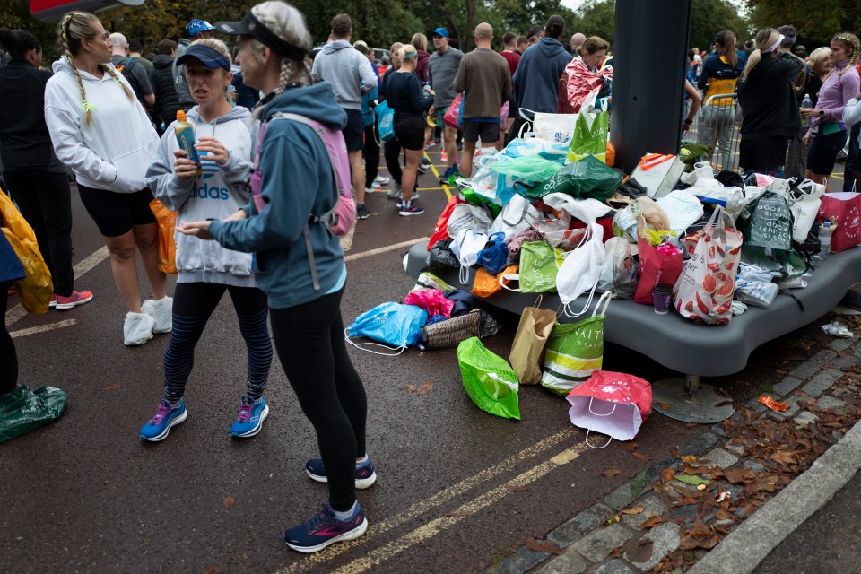 A huge pile of abandoned bags and clothing is seen ahead of today's race