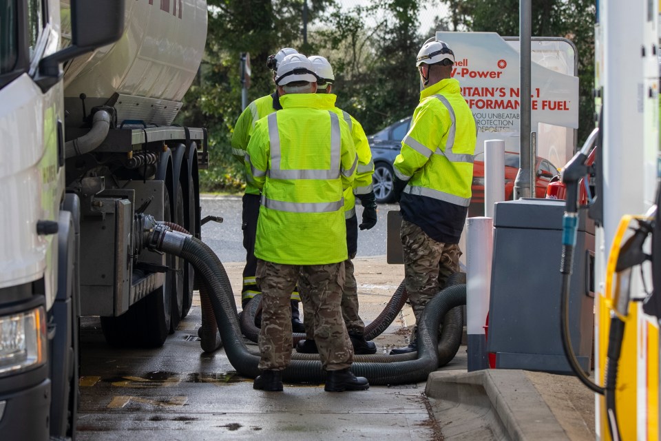 Soldiers wearing uniforms are seen delivering fuel at a Shell garage in the New Forest