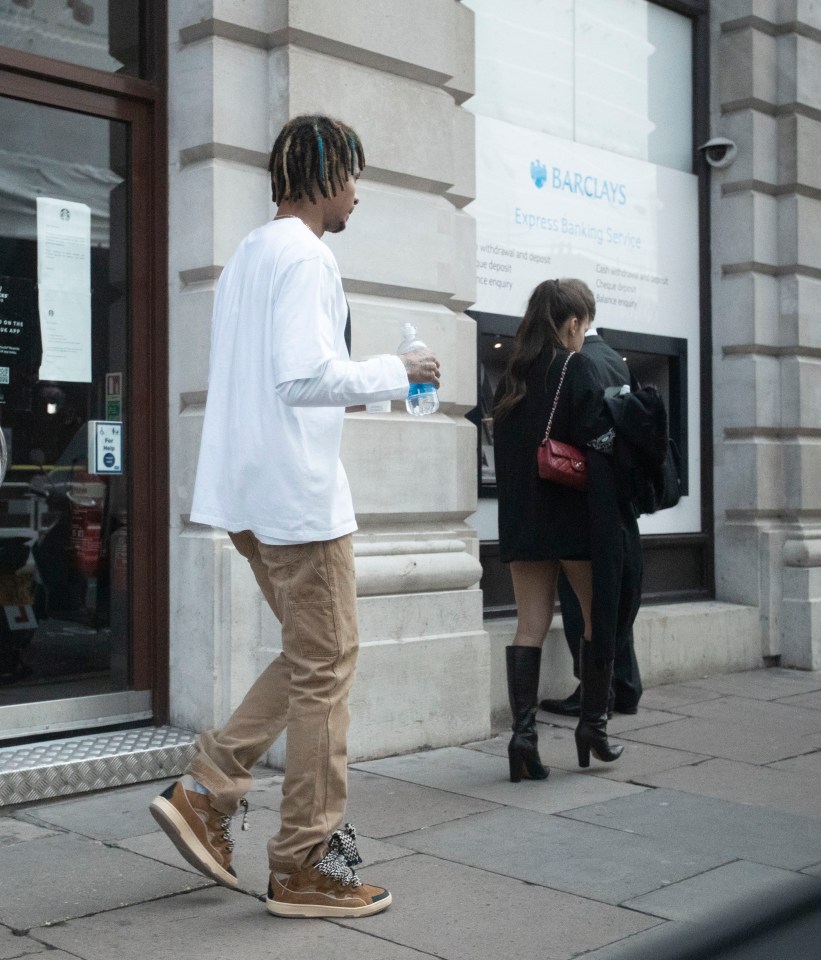 Dele rocked a long sleeve white top and chinos, with Maria in a black jumper and knee-high boots