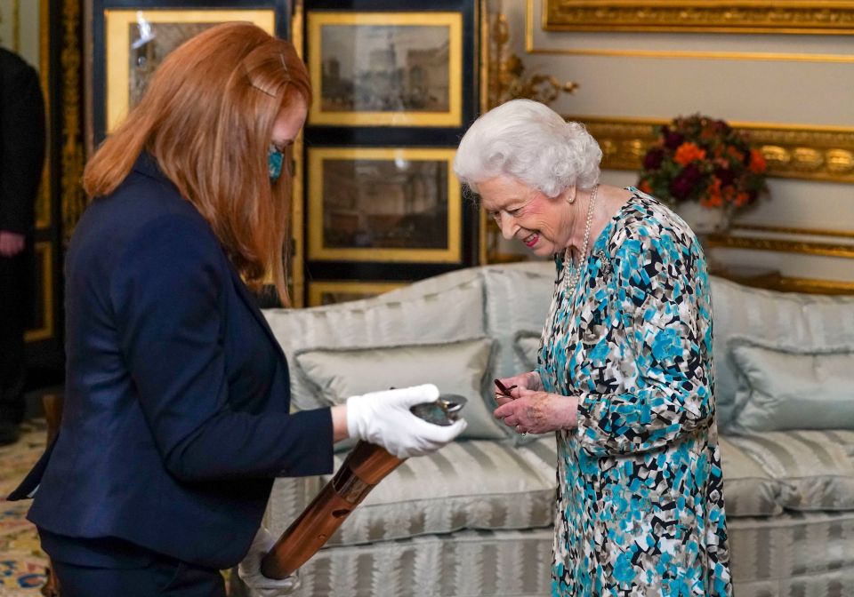 The 'smart' baton has locked Her Majesty's message inside until the opening ceremony in 2022