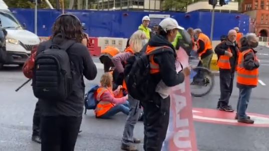 The banner-clutching demonstrators set up camp at their latest target