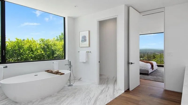 The ensuite boasts an impressive bathtub