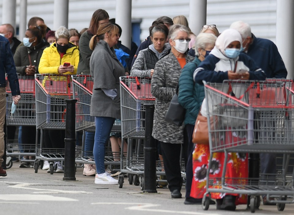 Long queues have been building up at stores, including this Costco in Manchester, as shoppers stock up ahead of Christmas