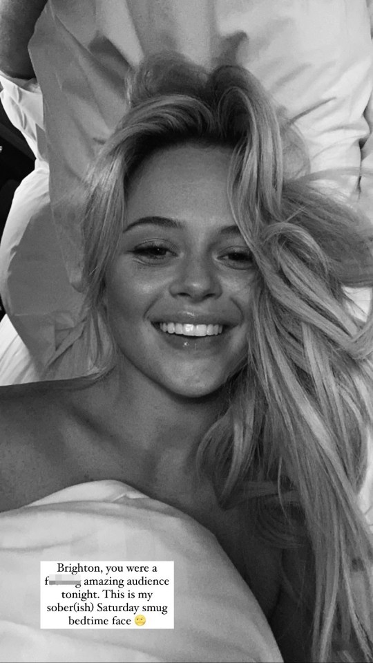 Emily Atack was all smiles in a sexy topless bed selfie after "forgetting her pyjamas"