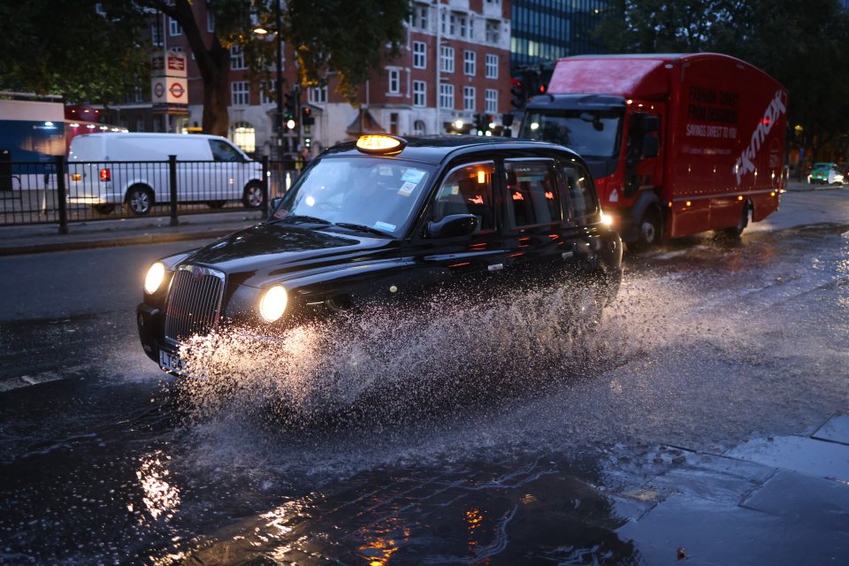 Surface water on the Euston Road in North London caused by heavy rain over night in the capital