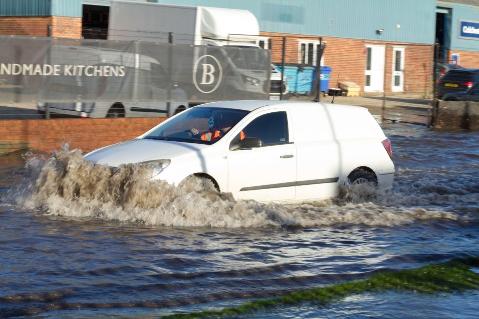 Traffic battles to get through the floodwaters in Colchester, Essex