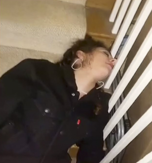 Terrifying images show the young woman slumped on the staircase struggling to move