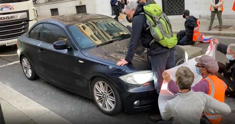 One demonstrator in London is seen leaning on a car on Southwark Bridge