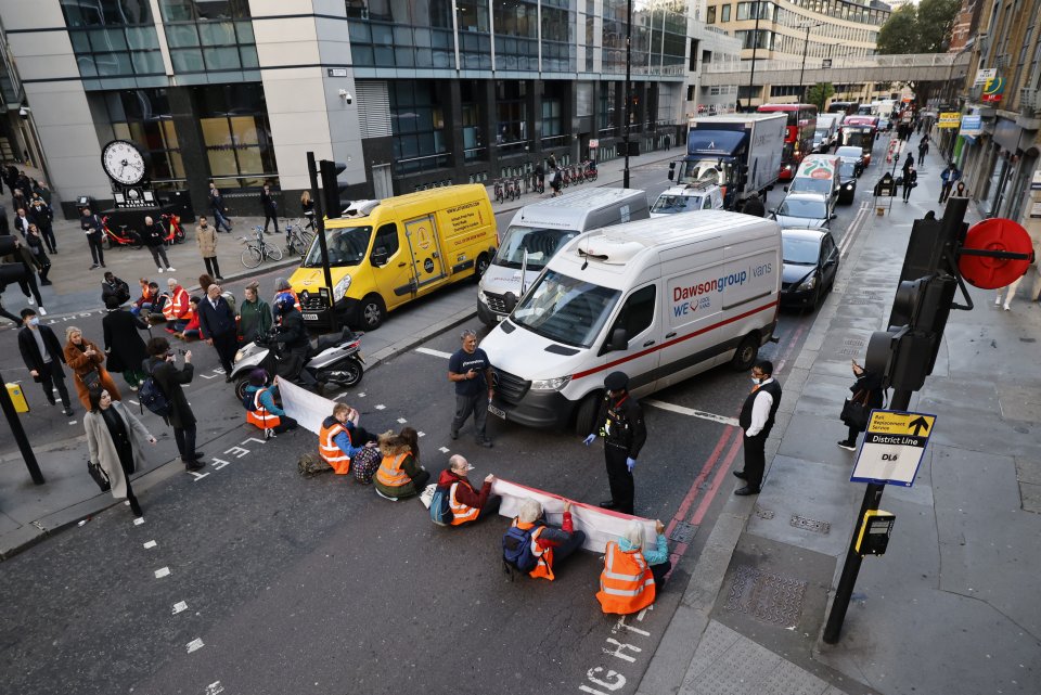 Insulate Britain activists are seen blocking roads close to Liverpool Street Station as they battle to get past the barricade