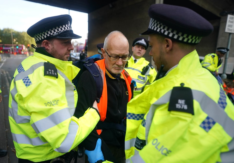 A man is arrested on a road near Canary Wharf