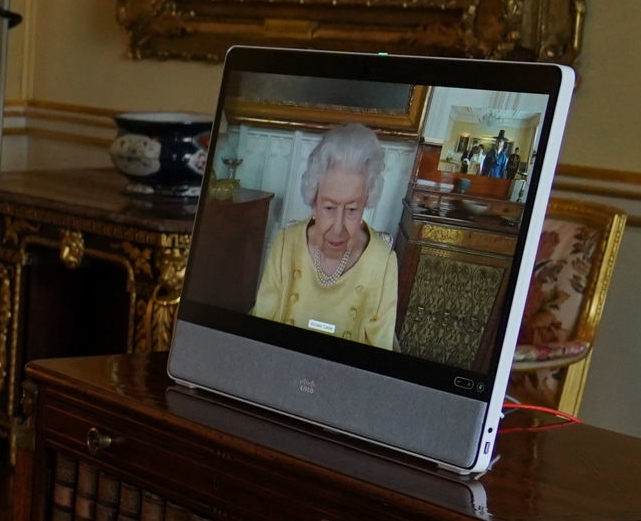 The Queen appears on a screen via video link from Windsor Castle