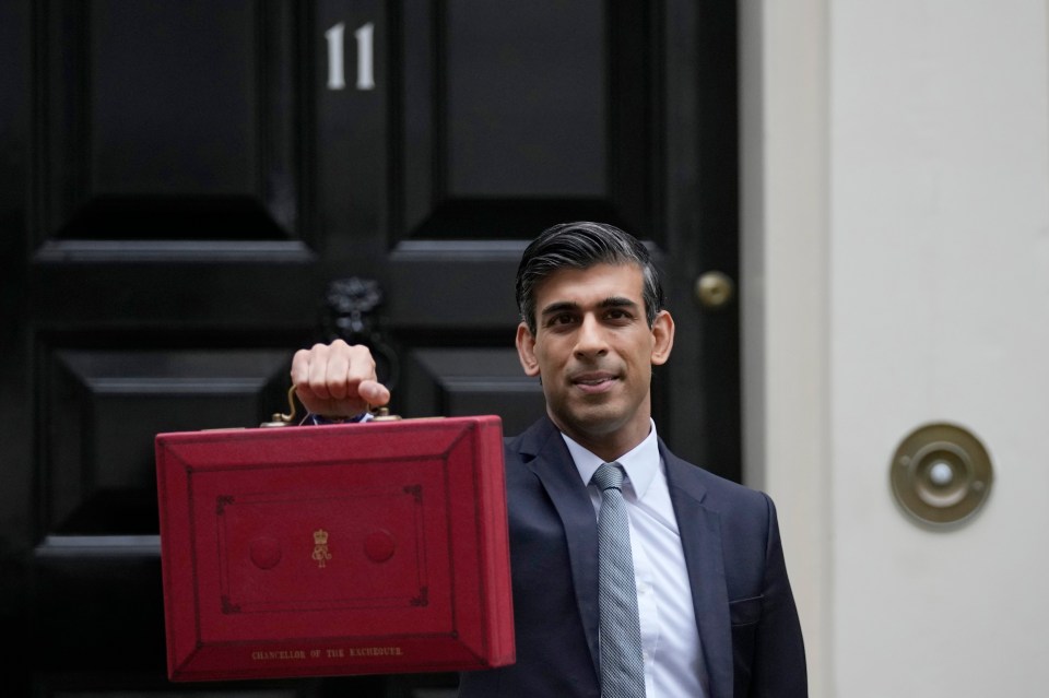 Rishi Sunak holds up his red box with the Budget outside No11 Downing St today