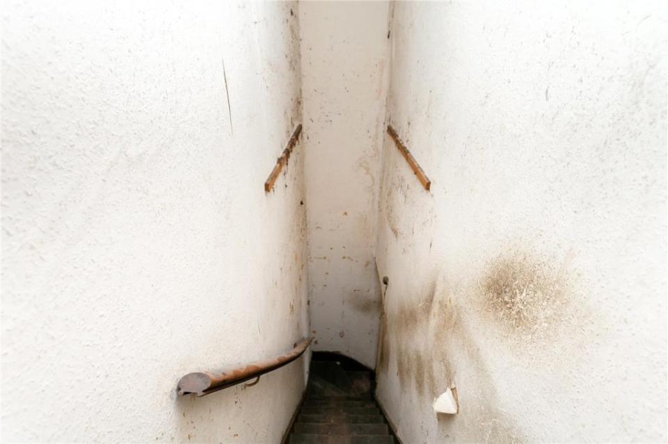 A tiny - and very creepy - staircase leads beneath the house