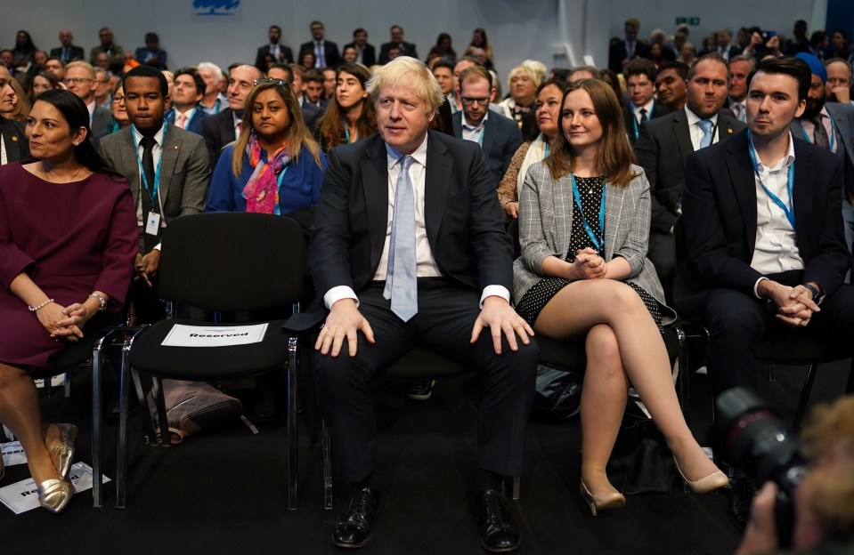 Boris Johnson watches on as Sunak gives his speech