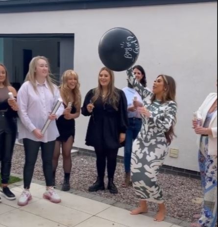 Chloe was seen holding the balloon, which would reveal her pal's baby's gender