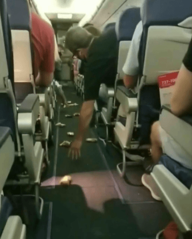 A flight attendant revealed a rather strange method to deliver snacks - by sliding them down the aisle