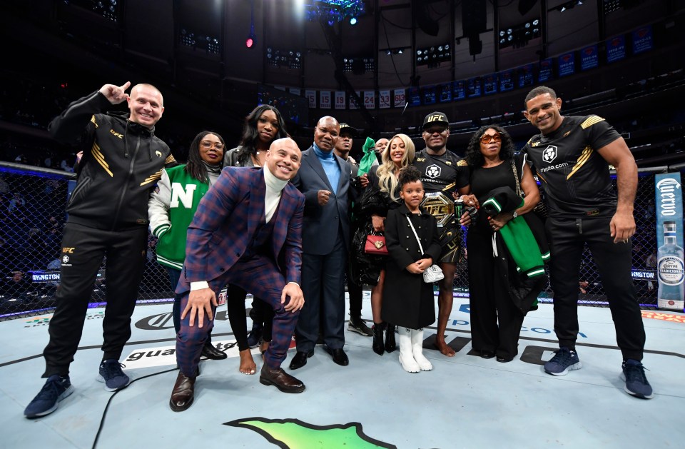 Usman celebrates his with team and family inside the octagon