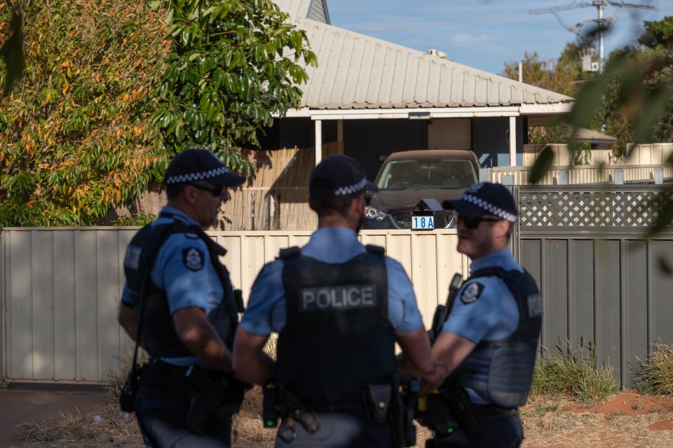 Police stand guard outside the house where missing girl Cleo Smith was rescued