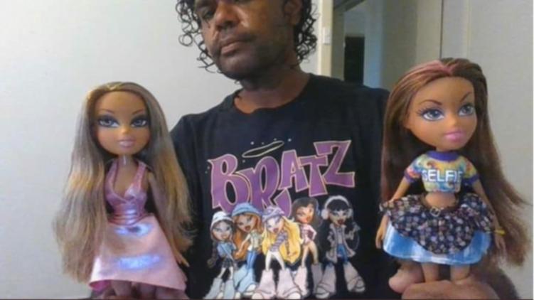 Terence Kelly posing with Bratz dolls