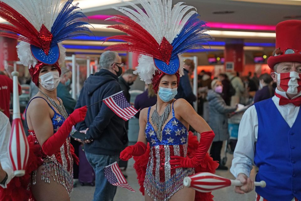 Performers entertain passengers at Heathrow as the US reopens its borders to UK visitors