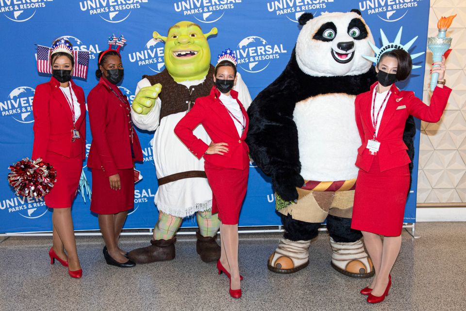 Virgin Atlantic staff pose at Heathrow before the synchronised departure of flights to the US