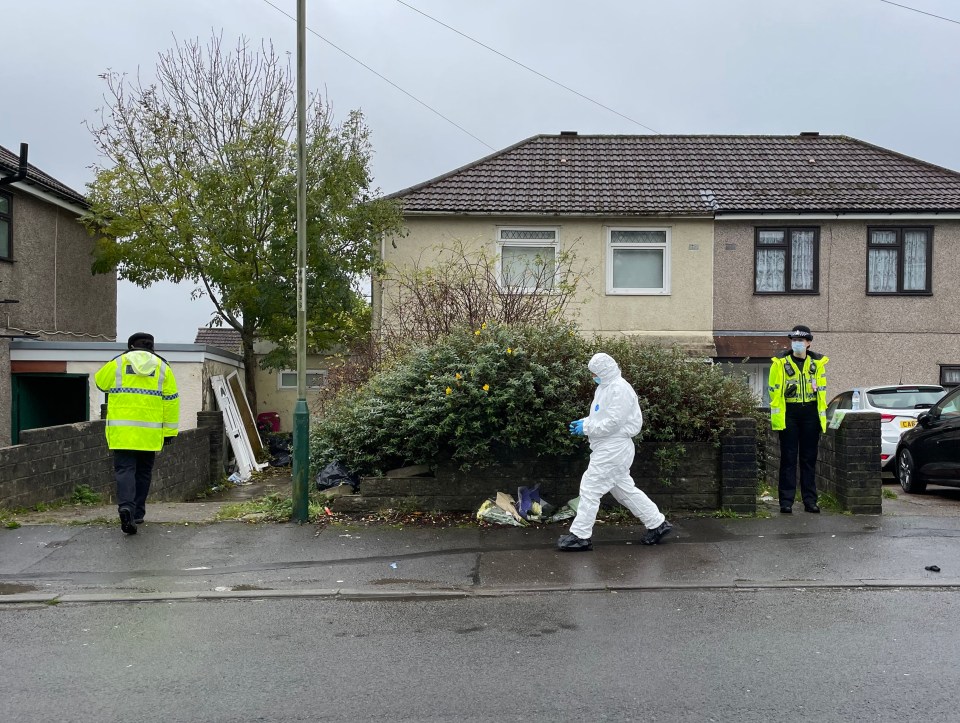 Forensics officers and cops remain at the scene