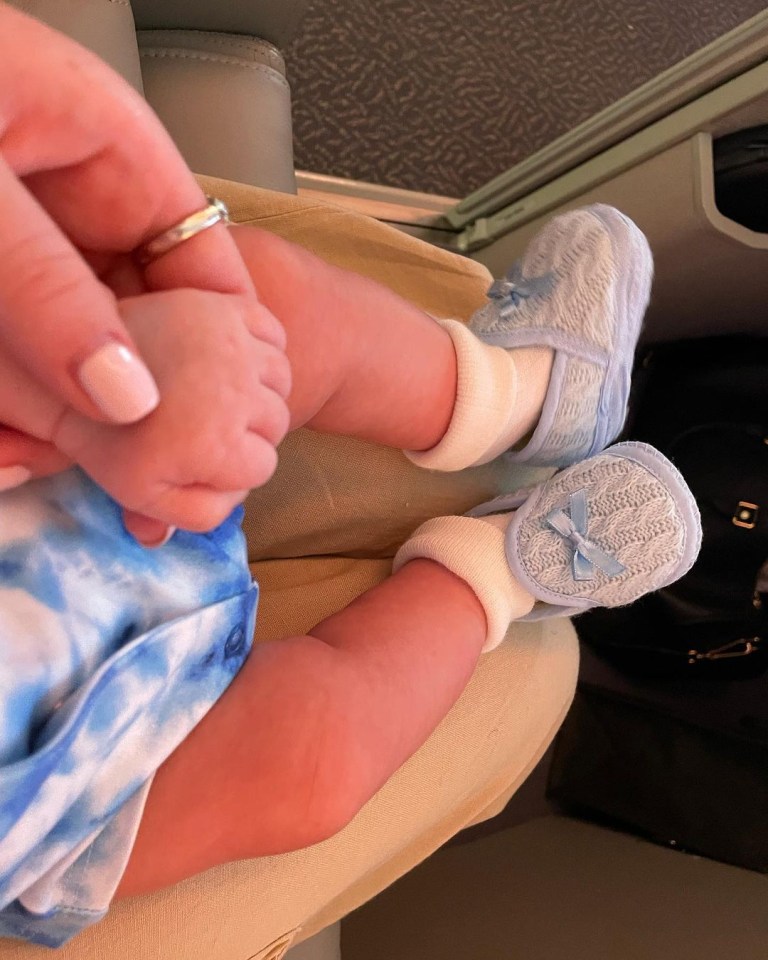 Perrie snapped baby Axel's teeny feet during the flight