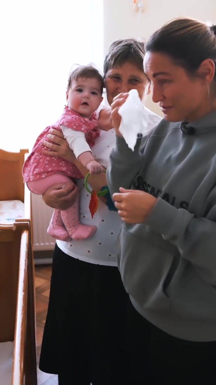 Sam wore a baggy jumper during a visit to an orphanage