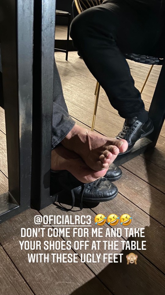 Terry mocked Carlos by snapping a shot of his toes under the table