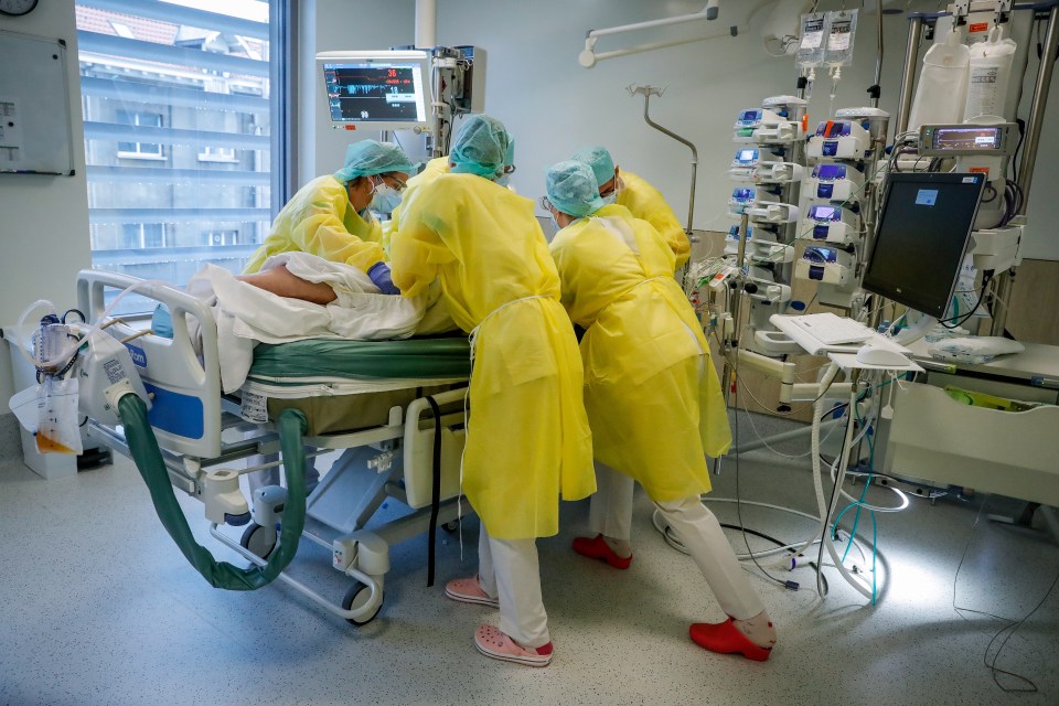 Medics in Brussels treat a Covid-19 ICU patient as they record their first Omicron case