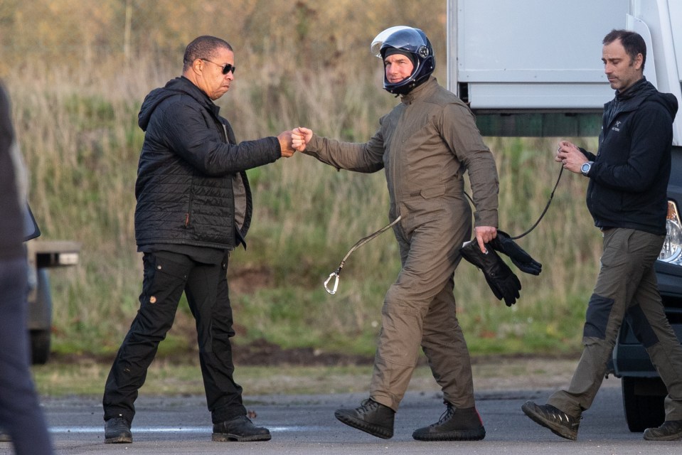 Tom fist-bumped the crew as he walked across the airfield