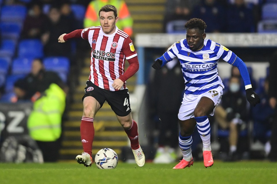 John Fleck, left,  left the Madejski Stadium in an ambulance after collapsing on the pitch - where he received six minutes of urgent medical attention