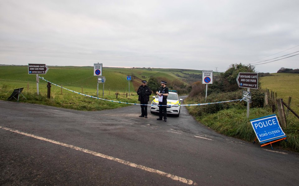 Officers where the body of a woman was found in Bovisand