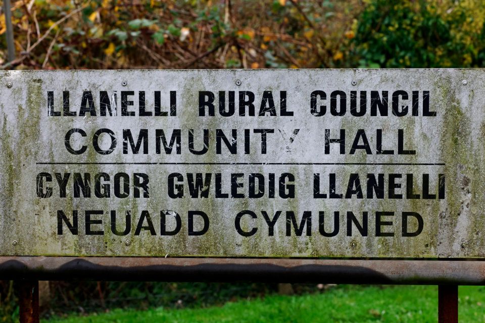 The sign for the abandoned community hall rusts and fades. along with nearly 30 empty properties