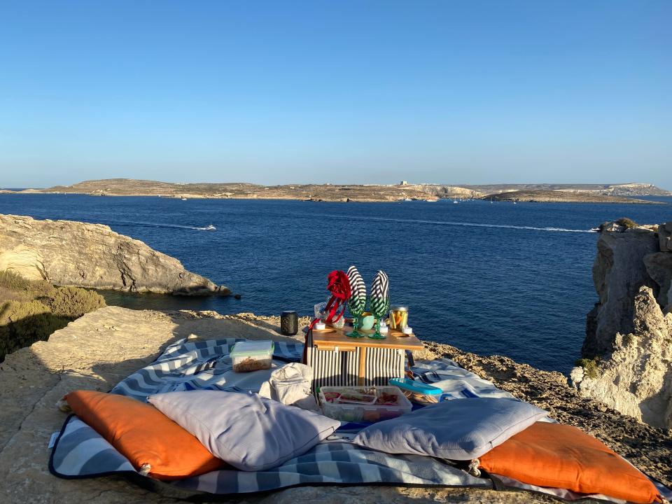 In front of us is a sumptuous-looking picnic on cushions