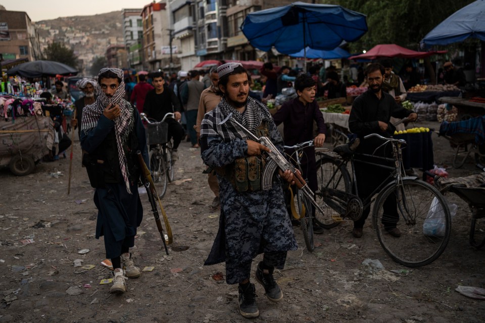 Whistleblower Raphael Marshall said thousands of emails from Afghans trying to flee went unread at the peak of the crisis – pictured Taliban fighters patrol a market in Kabul