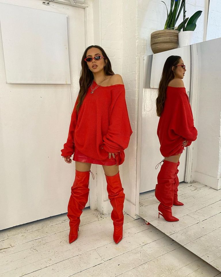 The chart-topper looks sensational dressed head-to-toe in a festive red number jumper which she wore with matching thigh-high boots