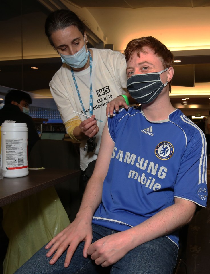 One of the grateful booster recipients dons a Chelsea shirt