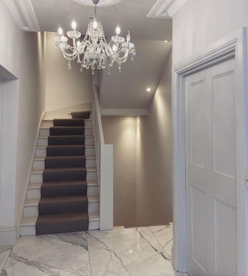 The hallway features marble flooring