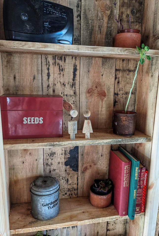 He used wooden pallets to make the door, and a wire, hook and piece of metal for the latch itself