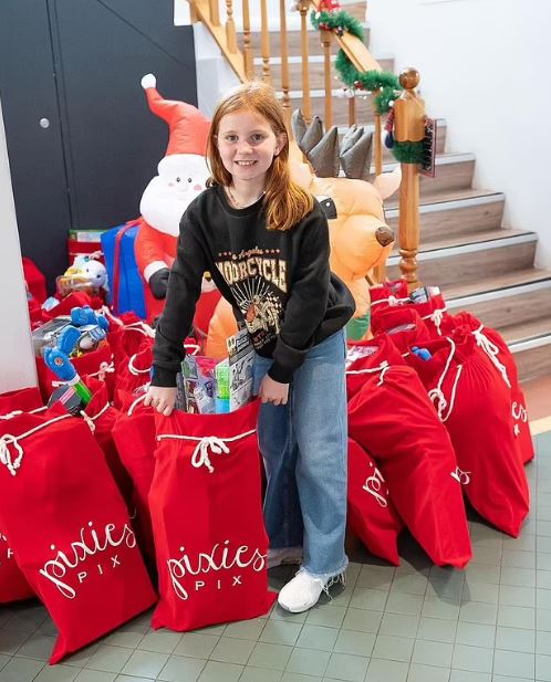 Girl donating toys to charity.