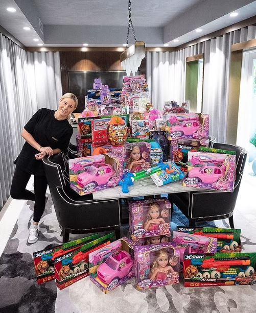 A girl donates a large collection of toys to less fortunate children.