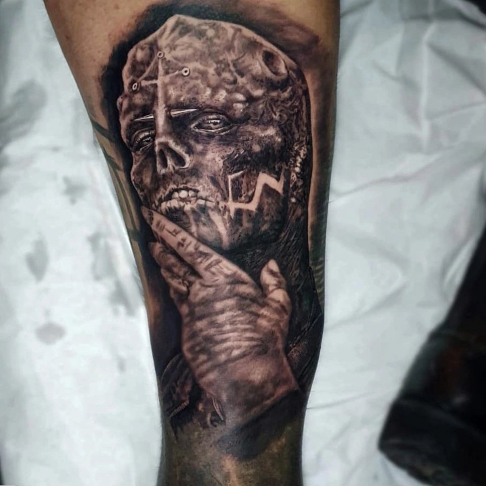 Michel spent eight hours in the tattoo clinic getting the new creepy image inked on his leg