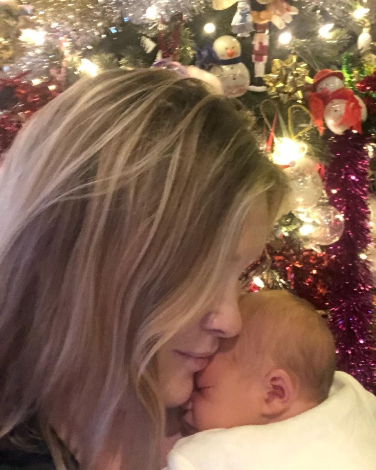 Joanna Page snuggled with baby girl Boe by the Christmas tree