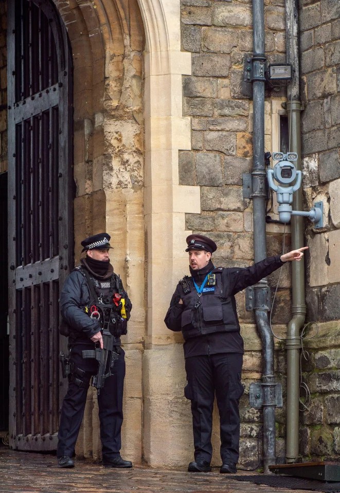 Armed police officers on guard at the Henry VIII Gate at Windsor Castle