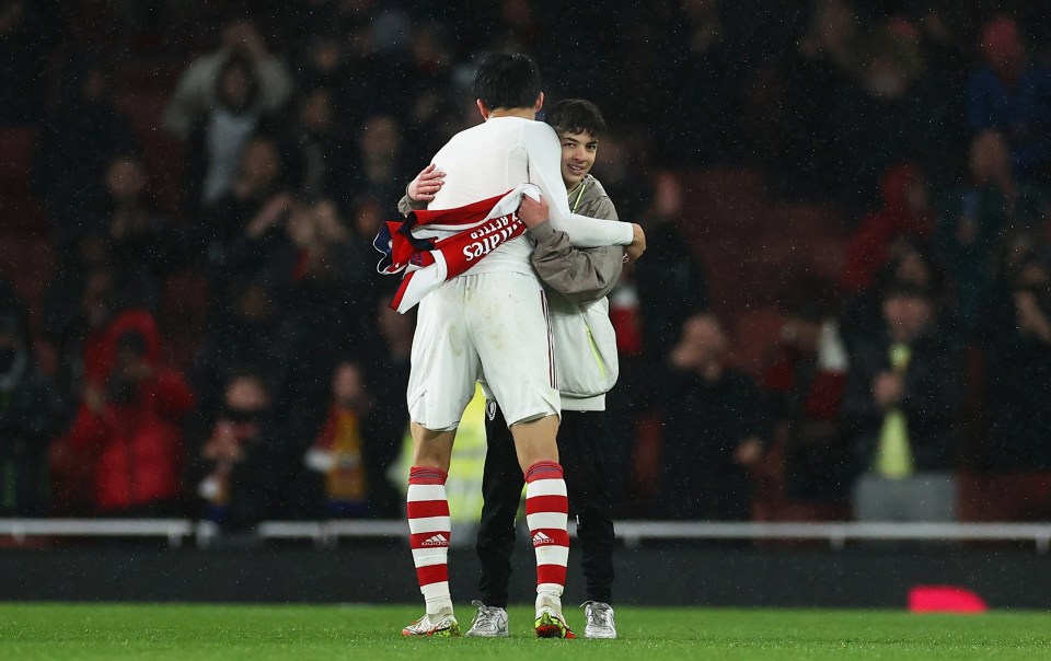 Takehiro Tomiyasu took a gentle approach to the pitch invader but one youngster was led off by security