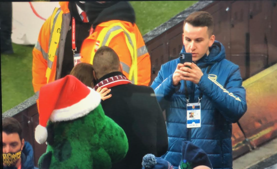 Gunnersaurus hovers in the background as the couple mark their special day