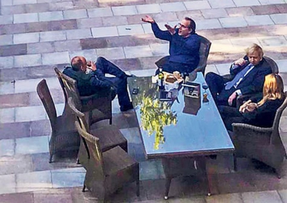 The Prime Minister is seen enjoying cheese and wine in the Downing Street garden with staff during the first Covid lockdown