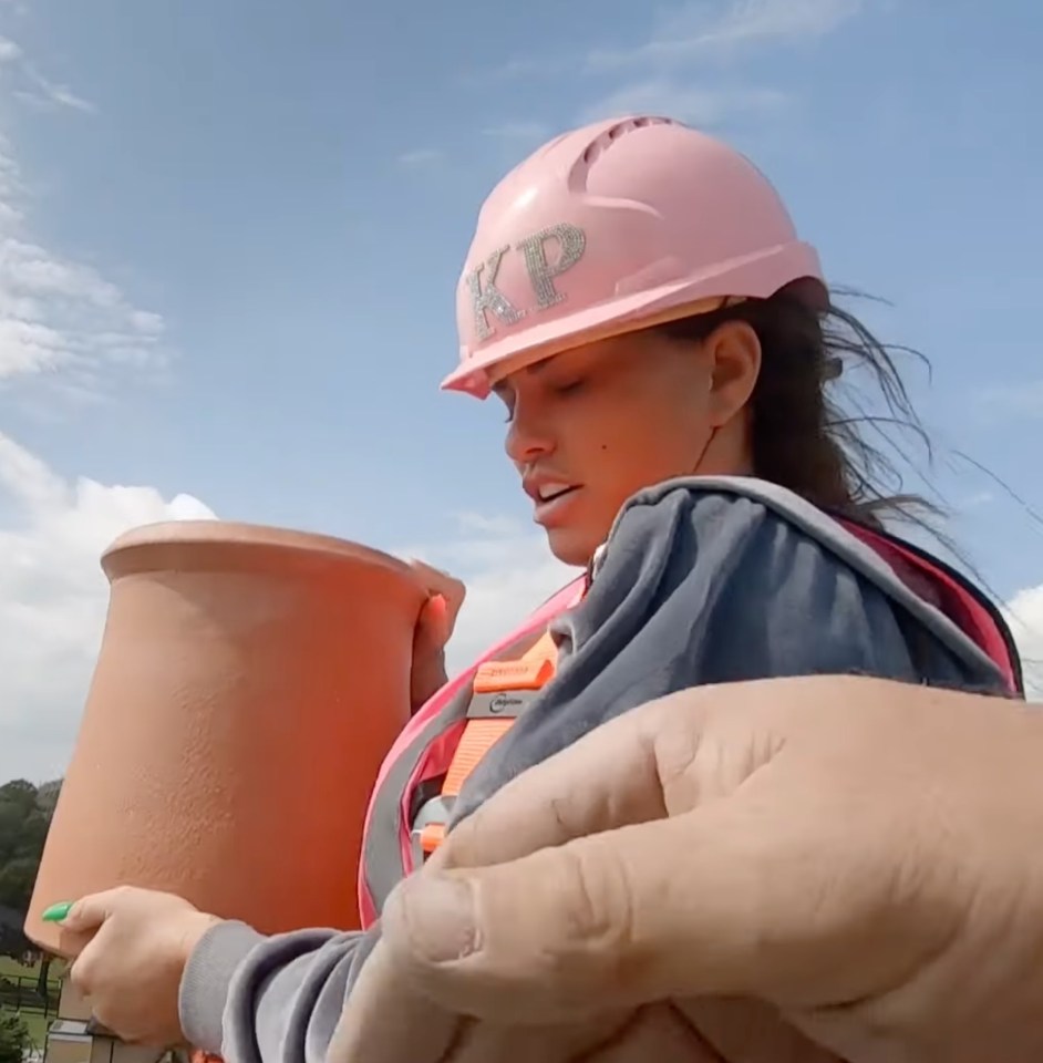 Katie Price is shown trying to lift up a chimney pot on her new C4 show