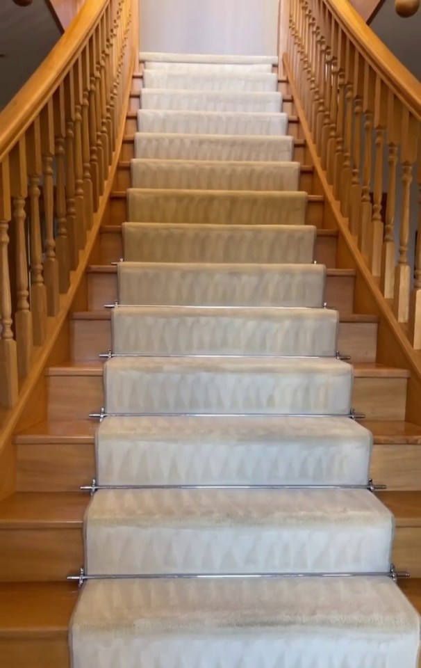 He showed off the sweeping staircase after having the carpets done